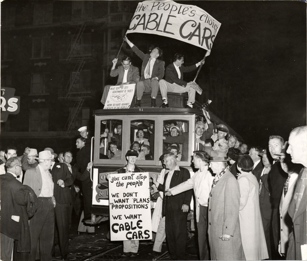 Hundreds of demonstrators surround cable car No. 51 on May 16, 1954, trying to stop it from completing the final run on the O'Farrell, Jones & Hyde line. MSR historian Phil Hoffman is in the middle on the roof. For the rest of his long life, Phil carried a scar on his hand from where the clapper on the roof bell whacked him as he held on.