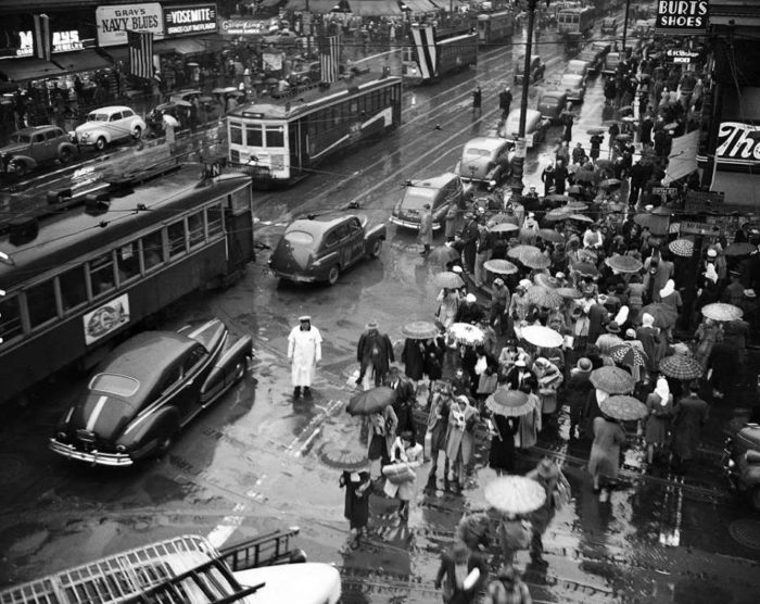 Rainy day looking east on Market Street from Fifth, 1943 or 1944. Lots of umbrellas and streetcars