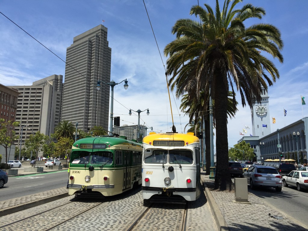 Vintage 1948 double-end PCC streetcars Nos. 1006 (left) and 1011 pass just south of the Ferry Building during E-line training, July 1, 2015